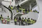 Bangladeshi immigrants evacuated from Libya are seen on the deck of the ferry 'Ionian King' docked inside Souda port in Crete, Greece, on Sunday March 6, 2011. Dozens of migrant workers evacuated by this ship from Libya to the Greek island of Crete apparently jumped overboard during the night, Greek authorities said Sunday, leaving three dead, 30 hospitalized and a further 16 missing.