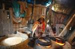 Hasina Begum, 50, makes puffed rice in a small factory at her home in Bakerganj, Bangladesh. The Market Infrastructure Development Project in the Charland Regions works with rural communities in order to directly benefit small enterprises and small-scale traders in the project area.