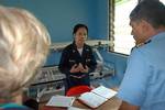 Lt. Cmdr. Leila Williams attached to Naval Health Clinic Hawaii, briefs her staff on patient movement for medical treatment at Bunabun Health Center, in Madang, Papua New Guinea.