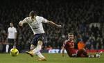 Tottenham Hotspur's Gareth Bale shoots at goal after being tackled by West Bromwhich Albion's Gareth McAuley during their English Premier League soccer match at Tottenham's White Hart Lane stadium in London, Tuesday, Jan. 3, 2012.