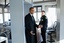 File - President Barack Obama talks to Secret Service Uniformed Division officers as he walks through the magnetometer in the Northwest Gatehouse at the White House, following his visit to Blair House, Dec. 9, 2011.