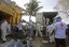 Forensic and Red Cross workers load into a truck bodies of inmates killed during a fire inside the prison in Comayagua, Honduras, Wednesday Feb. 15, 2012.