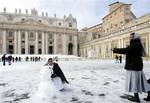 Nuns take pictures in the snow covered St. Peter's square at the Vatican, Saturday, Feb. 4, 2012.