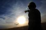 A U.S. Soldier assigned to Alpha Company, 4th Battalion, 10th Special Forces Group watches an Air Force CV-22 Osprey tiltrotor aircraft during Emerald Warrior 2011 March 1, 2011, at Cannon Air Force Base, N.M. Emerald Warrior is an annual two-week joint/combined tactical exercise sponsored by U.S. Special Operations Command designed to leverage lessons learned from operations Iraqi and Enduring Freedom to provide trained and ready forces to combatant commanders. (U.S. Air Force photo by Tech. Sg