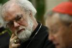 Archbishop of Canterbury Rowan Williams, left, looks at Cardinal Walter Kasper, President Emeritus of the Pontifical council for Promoting Christian Unity, as he speaks during a public commemoration to celebrate the 50th anniversary of the founding of the Secretariat for Promoting Christian Unity, at the Vatican,Wednesday.