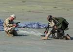 Photographers Mate 2nd Class Greg Badger, assigned to Combat Camera Group Pacific, videotapes a Pararesuceman assigned to the U.S. Air Force's 48th Rescue Squadron.