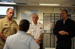 PORTSMOUTH, Va. -- Sector Hampton Roads Command Center Supervisor, Lt. Cmdr. Deborah Lindquist provides an operational briefing to Vice Adm. David Buss, Commander, Task Force 20; Rear Adm. David Gardam, Commander, Canadian Maritime Forces Atlantic and Vice Adm. Robert Parker, Commander, Atlantic Area during a tour of the Joint Harbor Operations Center, Dec. 2. The three representatives were part of a two day conference to discuss the mutual interests of the three agencies and how to enhance part