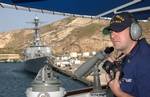 CARTAGENA, Spain (May 28, 2005)--Petty Officer 3rd Class (OS) Jason Yonk mans a sound-powered phone as the Coast Guard Cutter Bear pulls into Cartagena, Spain alongside the USS Mahan May 28. USCG photo by PA2 Andrew Shinn (101700) ( BEAR AFRICA DEPLOYMENT (FOR RELEASE) )