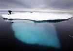 This is a July 2007 file image of a Inuit seal hunter Dines Mikaelsen as he touches a dead seal atop a melting iceberg near Ammassalik Island, Greenland.