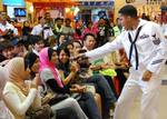 Musician 1st Class Christopher Sams enlists the help of the audience for a Michael Jackson song during a concert at Kuantan Parade Mall.