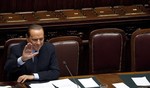 File - Italian Premier Silvio Berlusconi waves after delivering his speech at the Lower Chamber, in Rome, Thursday, Oct. 13, 2011.