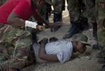 Civilian volunteers receive military instruction from Samson Chery, 42, left, former member of Haiti's dissolved army in Port-au-Prince, Haiti, Saturday, Nov. 12, 2011. Haiti's President Michel Martelly is going forward with a plan to restore his country’s disbanded army