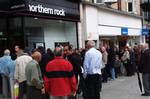 A Monday Sept. 17, 2007 photo showing customers standing in a queue outside a branch of the Northern Rock the British mortgage lender in Harrow, London. Shares of British mortgage lender Northern Rock PLC, hit by a liquidity crisis which sent customers lining up to withdraw billions in deposits, tumbled more than 30 percent Monday Sept. 17. Britain's first bank run in almost a century has prompted the government Monday Oct. 15, 2007, to take a cue from the U.S. response to the Great Depression a