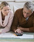 Image: Couple preparing taxes (© Tetra Images/Tetra images RF/Getty Images) // Image: Couple preparing taxes (© Tetra Images/Tetra images RF/Getty Images)