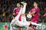 Real Madrid's Xabi Alonso, center, challenges for the ball with Lyon's Anthony Reveillere, left, and Dejan Lovren, right, during their Champions League soccer match at Gerland stadium, in Lyon, central France, Wednesday, Nov. 2, 2011.