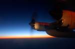 NORTH POLE 01:BARROW, Alaska--The sun rises off the right side of a Coast Guard C-130 Hercules airplane on its way to the North Pole Thursday morning. The sun soon disappeared below the horizon as the aircraft entered Arctic latitudes not reached by the rising winter sun. The sun reappeared on the horizon upon returning toward Barrow. (Official U.S. Coast Guard photo by Petty Officer 1st Class Kurt Fredrickson) (183169) ( NORTH POLE (For Release) )