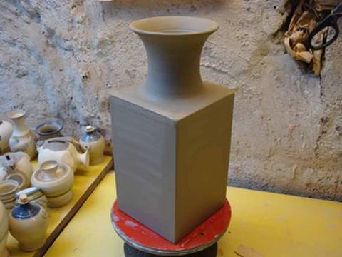 Making / Throwing a square pottery clay vase on the wheel