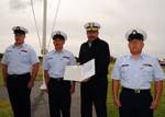 MIDDLETOWN, Calif. - Rear Adm. Joseph Castillo, holds the Meritorious Unit Commendation award certificate presented to the crew of Coast Guard Loran Station Middletown during the decommissioning ceremony of the facility, May 21, 2010. The loran station began as a radio-based navigation system during World War II under a secret program to provide the Allied forces with a reliable and accurate means of navigation at sea in any weather. The loran station crew ceased broadcasting of their domestic s