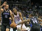 Oklahoma City Thunder's Kevin Durant (35) loses control of the ball as he tries to get between Orlando Magic's Hedo Turkoglu (15) and Jameer Nelson (14) during the first half of an NBA basketball game on Thursday, March 1, 2012, in Orlando, Fla. (AP Photo/John Raoux)