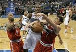 Milwaukee Bucks' Drew Gooden (0) and Ersan Ilyasova (7) battle with Orlando Magic's Dwight Howard, center, for a rebound during the first half of an NBA basketball game, Saturday, March 3, 2012, in Orlando, Fla. (AP Photo/John Raoux)