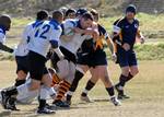 Cmdr. Greg McGuire, a center for the aircraft carrier USS George Washington (CVN 73) Rugby Football Club, pushes into a maul during a game.