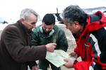 Capt. Ljubinico Petic (middle) of the Montenegrin air force plans a flight route along with citizens of the town of Mojkovac as soldiers from U.S. Army Europe's 12th Combat Aviation Brigade conduct a resupply mission to deliver goods to Montenegrins stranded by severe weather in Northern Montenegro on Friday, Feb. 24, 2012. The soldiers are here as part of a U.S. task force to provide humanitarian assistance at request of the government of Montenegro coordinating with the National Emergency Oper