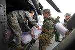 Supplies are off loaded from a vehicle to begin loading the UH-60 A+ Black Hawk helicopter Feb. 22, 2012. The soldiers are here as part of a U.S. task force to provide humanitarian assistance at request of the government of Montenegro coordinating with the National Emergency Operations Center and the Montenegrin Ministry of Defense to provide relief and to save lives, homes and infrastructure in response to heavy snowfall.