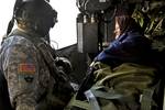 Staff Sgt. Gerald Winchester from the U.S. Army Europe's 12th Combat Aviation Brigade monitors a Montenegrin citizen during an air medical evacuation while working under a Task Force led by 361st Civil Affairs Brigade. The soldiers are here as part of a U.S. task force to provide humanitarian assistance at request of the government of Montenegro coordinating with the National Emergency Operations Center and the Montenegrin Ministry of Defense to provide relief and to save lives, homes and infras