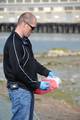 ALAMEDA, Calif. -- Petty Officer 1st Class Clint Leslie, from Electronic Systems Support Unit Alameda, disposes of a needle, found on the shores of Coast Guard Island, into a hazardous materials box during the Earth Day cleanup celebration Thursday, April 21, 2011. Earth Day is a platform to educate the world about important environmental issues facing our planet. U.S. Coast Guard photo by Petty Officer 3rd Class Levi Read. (1211060) ( Earth Day cleanup at Coast Guard Island )