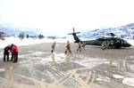 The citizens of the town of Mojkovac along with soldiers from the Montenegrin army load food and supplies received from soldiers from U.S. Army Europe's 12th Combat Aviation Brigade as they conduct a resupply mission to deliver goods to Montenegrins stranded by severe weather in Northern Montenegro on Friday, Feb. 24, 2012. The Soldiers are here as part of a U.S. task force to provide humanitarian assistance at request of the government of Montenegro coordinating with the National Emergency Oper