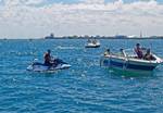 Greg McGrath, ADSO-OPS (PWC), assists distressed boater at Chicago Air & Water show. Navy Pier is in the background. Photo by Barney Zaffron, USCGAUX. (878911) ( Chicago Air & Water show )