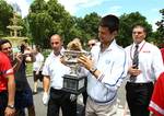 Australian Open men's singles champion Serbia's Novak Djokovic walks with his trophy at a park in central Melbourne, Australia, Monday, Jan. 30, 2012. Djokovic defeated Spain's Rafael Nadal in five hours and 53 minutes to win a third Australian Open title earlier in the day.