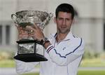 Australian Open men's singles champion Serbia's Novak Djokovic poses with his trophy at a park in central Melbourne, Australia, Monday, Jan. 30, 2012. Djokovic defeated Spain's Rafael Nadal in five hours and 53 minutes to win a third Australian Open title earlier in the day.