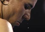 Beads of sweat drop off the face of Spain's Rafael Nadal during a break as he plays Novak Djokovic of Serbia in their men's singles final at the Australian Open tennis championship, in Melbourne, Australia, Sunday, Jan. 29, 2012.