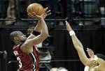 Miami Heat's Dwyane Wade, left, puts up a shot at the buzzer over Indiana Pacers' Brandon Rush, right, at the end of an NBA basketball game in Indianapolis, Wednesday, March 25, 2009. Wade's shot missed and Indiana won 90-88. (AP Photo/Tom Strattman)