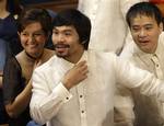 Congressman and Filipino boxing hero Manny Pacquiao, center, gestures as he talks with fellow lawmakers during the 15th congress at the House of Representatives in suburban Quezon City, north of Manila, Philippines on Monday, July 25, 2011.