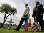 U.S. Ambassador Harry K. Thomas Jr. right, walks with Undersecretary and Executive Director of the Visiting Forces Agreement Commission, Edilberto Adan, during U.S. Memorial Day at the Manila American Cemetery and Memorial, said to be the largest to house U.S. troops killed during World War II, at Fort Bonifacio, Taguig city, south of Manila, Philippines on Sunday May 30, 2010. More than 17,000 American military, including 570 Filipinos who served with the U.S. Forces in the southwest pacific, h