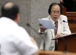 Filipino lawyer Serafin Cuevas, right, lead defense counsel in the impeachment trial of Supreme Court Chief Justice Renato Corona, not in photo, cross-examines prosecution witness Roberto Anduiza, left, at the Senate in Manila, Philippines, Wednesday, Feb. 8, 2012. The Philippines' first impeachment trial of a Supreme Court justice opened last month, in a major battle of President Benigno Aquino III's anti-corruption campaign targeting his detained predecessor and her allies. (AP Photo/Rolex Del