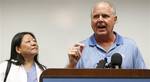 Conservative talk show host Rush Limbaugh, right, speaks during a news conference as Joana Magno, MD chief of the Dept. of Cardiovascular Diseases at The Queen's Medical Center looks on in Honolulu, Friday, Jan. 1, 2010. Limbaugh was rushed to the hospital after experiencing chest pains similar to a heart attack Wednesday during a vacation. (AP Photo/Chris Carlson)