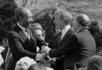 President Jimmy Carter shaking hands with Egyptian President Anwar Sadat and Israeli Prime Minister Menachem Begin at the signing of the Egyptian-Israeli Peace Treaty on the grounds of the White House.