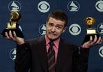 Justin Timberlake reacts as he holds the awards he won for best male pop vocal performance and best pop vocal album at the 46th Annual Grammy Awards, Sunday, Feb. 8, 2004, in Los Angeles.