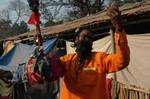 Indian Sadhu, or Hindu holy rest at a temporary camp at Babughat in Kolkata on 05 Jan 2012. Thousands of Hindu pilgrims taka holy dip at Gangasagar, hoping to wash away sins and others to secure a fine spouse, in a sun-worshipping tradition older than Hinduism itself in Eastern India City