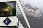 The Logo of Bank LGT (Liechtenstein Global Trust) with Vaduz castle in the background is seen Friday Feb. 15, 2008, in Vaduz, Liechtenstein. LGT Group is the largest private wealth and asset management group in Europe to be fully owned as a family business. German authorities searched Thursday Feb. 14, 2008, German Deutsche Post Chief Executive Klaus Zumwinkel's home and offices in a tax evasion investigation in connection with a foundation in Liechtenstein, according to media reports. LGT Group