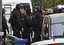 French special intervention police officers of Research Assistance Intervention Dissuasion unit, RAID, are seen near a building where the chief suspect in an al-Qaida-linked killing spree is holed up in an apartment in Toulouse, France Thursday March 22, 2012.