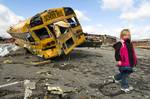 Madeline Evans of Henryville, Ind., walks the parking lot of her elementary school, March 3, 2012. The school and much of her town was devastated by a large tornado less the day before. The Indiana National Guard activated more than 250 soldiers to come to the aid of the community.