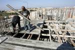 Palestinian laborours work to construct new houses in a project funded by the United Nations Relief and Works Agency for Palestine Refugees (UNRWA) in Rafah, in the southern of Gaza Strip on December 28, 2011. Israel maintains a tight blockade on the Palestinian territory building into Gaza since Islamist Hamas took control over the Palestinian territory in 2007 but supplies may only be brought by recognised international organisations managing specifically approved projects.. Photo by Ahmed Dee