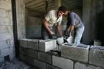 Palestinian laborours work to construct new houses in a project funded by the United Nations Relief and Works Agency for Palestine Refugees (UNRWA) in Rafah, in the southern of Gaza Strip on December 28, 2011. Israel maintains a tight blockade on the Palestinian territory building into Gaza since Islamist Hamas took control over the Palestinian territory in 2007 but supplies may only be brought by recognised international organisations managing specifically approved projects.. Photo by Ahmed Dee