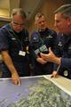 PORTLAND, Maine- Rear Adm. Joseph Nimmich (LEFT) examines a nautical chart while Capt. James McPherson (RIGHT) explains details of the Spill of National Significance Drill, March 23, 2010. The oil spill exercise takes place every three years throughout the country and provides an opportunity for emergency responders to practice a joint response to a major spill. (Photo by U.S. Coast Guard Petty Officer 2nd Class Etta Smith) (813362) ( SONS 2010 )