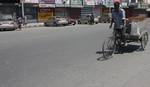 A man ride a rickshaw infront of closed shops During a strike in Srinagar on 09, August 2011. Normal life in the Kashmir Valley was disrupted today due to a Strike called by Kashmir Economic Alliance (KEA), an amalgam of traders' Shops and business establishments across the Valley remained closed KEA has been demanding inclusion of revocation of additional taxes on property, power and water, end to the exploitation of the state's natural resources, revocation of new VAT return forms and immediat