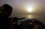 NORTH ARABIAN GULF (April 10, 2003)--Gunners Mate 3rd Class Osvaldo L. Perez, 23, of Myrtle Beach S.C., stands watch onboard the U.S. Coast Guard Cutter Adak, homeported in Sandy Hook, NJ., in the North Arabian Gulf off the coast of Iraq April 10, 2003. The Adak is one of four 110-foot patrol boats in the Gulf region in support of Operation Iraqi Freedom - the first time Coast Guard patrol boats have been deployed to a theater of war since Vietnam. USCG photo by PA1 Tom Sperduto (88074) ( OPERAT